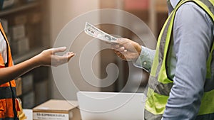 Closeup worker hand receiving cash money from paying person for salary bonus pay off debt or graft concept