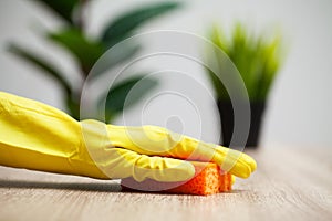 Closeup of worker hand wiping dust in office