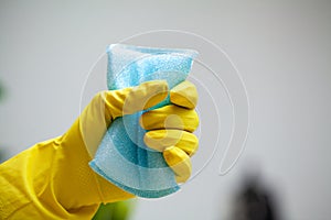 Closeup of worker hand wiping dust in office