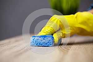 Closeup of worker hand wiping dust in office