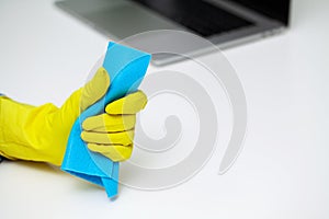 Closeup of worker hand wiping dust in office