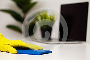 Closeup of worker hand wiping dust in office