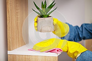 Closeup of worker hand wiping dust in office