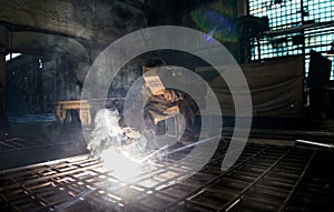 Closeup worker in a mask doing the welding in a workshop