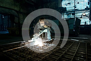 Closeup worker in a mask doing the welding in a workshop