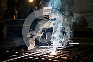 Closeup worker in a mask doing the welding in a workshop
