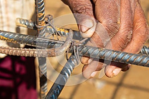 Worker Tying Intersecting Rebar Rods