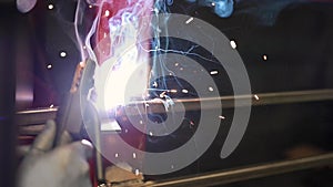 Closeup worker using electric arc welding machine to weld steel by manual skill labor in slow motion.