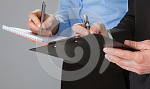 Closeup of working business team taking notes