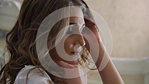 Closeup of a worried face of a girl with curly hair