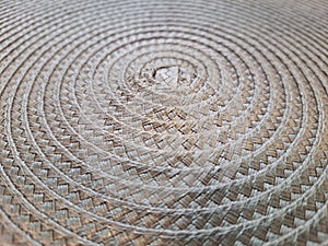 Closeup of a woven straw background, in a spiral shape.