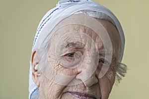 Closeup wrinkled face of a thoughtful senior woman