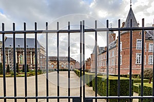 Closeup of wrought steel fence with outside garden and part of Alden Biesen castle