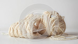 Closeup of a yarn of beige thread on  a white background