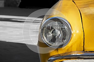 Closeup of yellow classic vintage car.