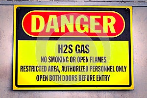 Closeup of a yellow Danger H2S Gas sign