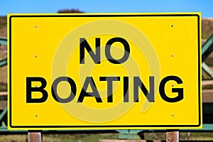 Closeup of a yellow no boating sign