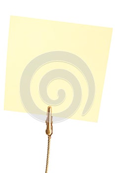 Closeup of yellow sticky note hold by clip