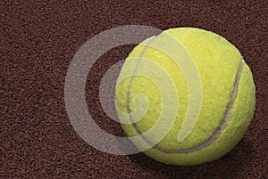 Closeup yellow tennis ball red background concept