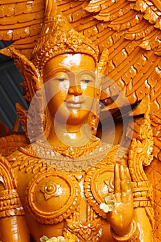 Closeup yellowish Candle statue of lady angel, one of the sculpture on parade of Thailand`s annual buddhism traditional festival