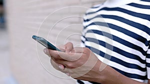 Closeup young african american man using mobile phone outdoor