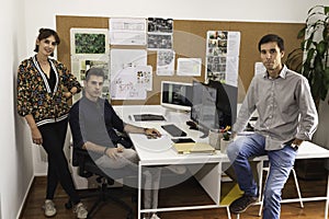 Closeup of young architects discussing together inside a conference room