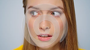 Closeup young attractive woman showing silence sign on grey background.