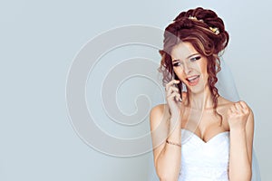 Closeup of young bride shouting on mobile phone unhappy angry