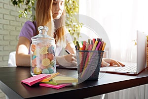 Closeup of young businesswoman working at modern office making notes