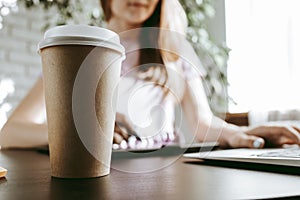 Closeup of young businesswoman working at modern office making notes