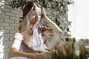 Closeup of young businesswoman working at modern office making notes