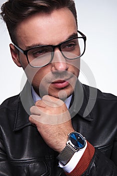 Closeup of a young casual man sthinking