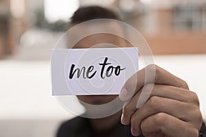 Man showing a note with the text me too photo
