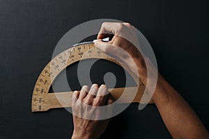 Young man using a protractor