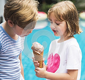 Closeup of young caucasian sibling sharing ice cream together