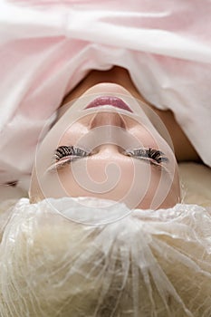 Closeup of Young Caucasian Woman Face, Lips and Eyebrows During a Process of Permanent Lips Makeup in Tattoo Salon