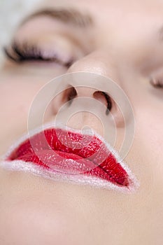 Closeup of Young Caucasian Woman Face And Lips During a Process of Permanent Lips Makeup in Tattoo Salon