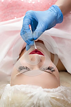 Closeup of Young Caucasian Woman Lips During a Process of Permanent Lips Makeup in Tattoo Salon