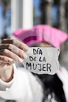 Woman with pink hat and text womens day in spanish photo