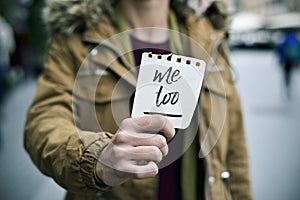 Woman showing a note with the text me too photo