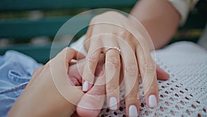 Closeup young couple hands holding at romantic date. Engaged man woman love