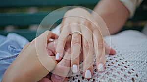 Closeup young couple hands holding at romantic date. Engaged man woman love