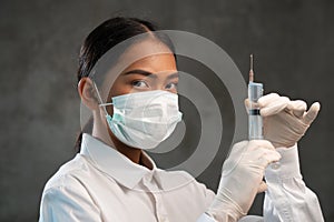 Closeup of young female doctor with syringe