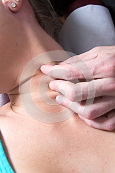 Closeup of young female patient neck massage