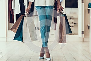 Closeup Young Girl holding Shopping Bags in Store