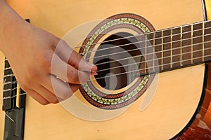 Closeup of a young girl playing guitar