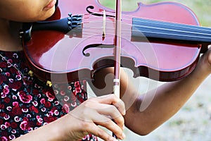 Closeup of a young girl playing violin