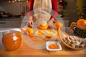 Closeup on young housewife making orange jam