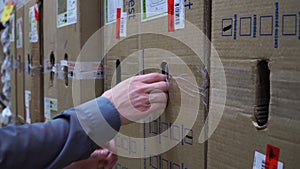 Closeup young man looking for box at store warehouse shelf 4k