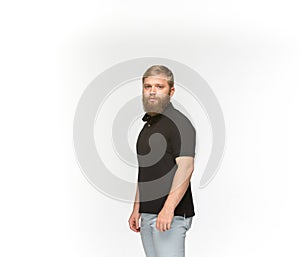 Closeup of young man`s body in empty black t-shirt isolated on white background. Mock up for disign concept